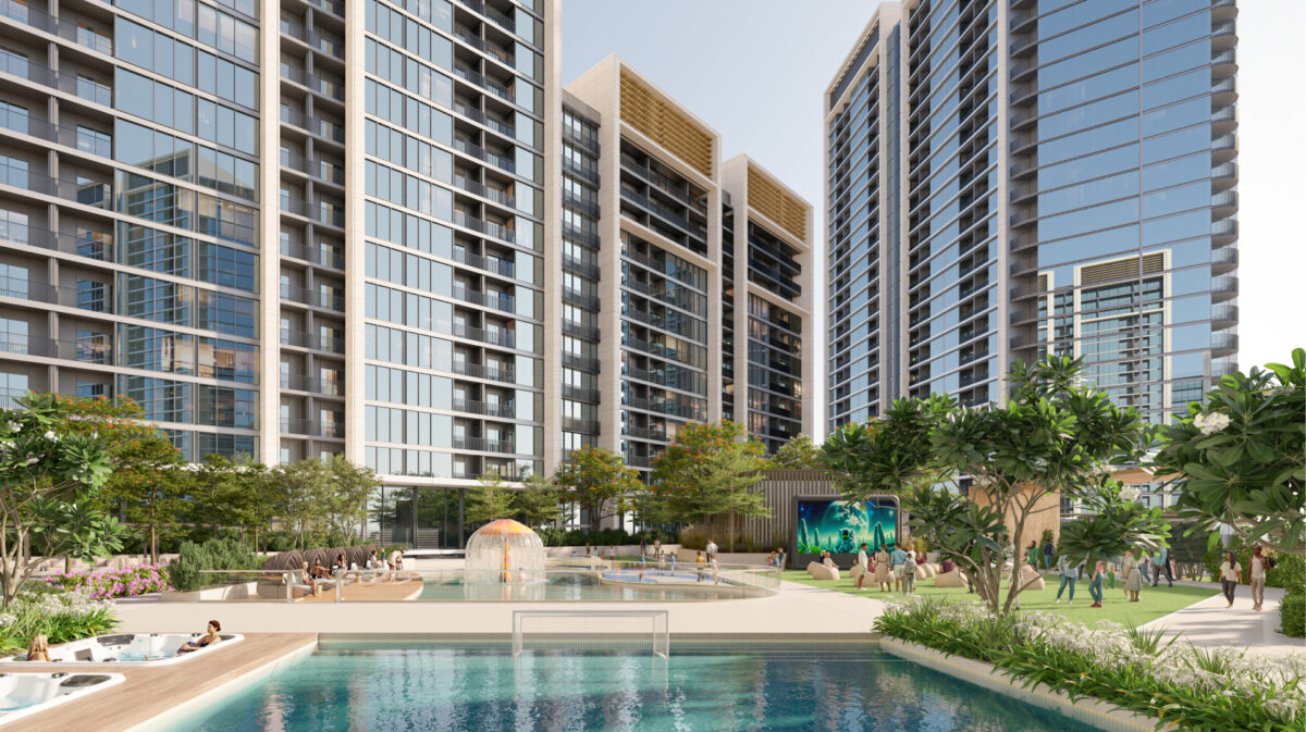 A residential complex with modern towers framing a relaxation area featuring a pool, green spaces, and a welcoming, family-friendly ambiance.